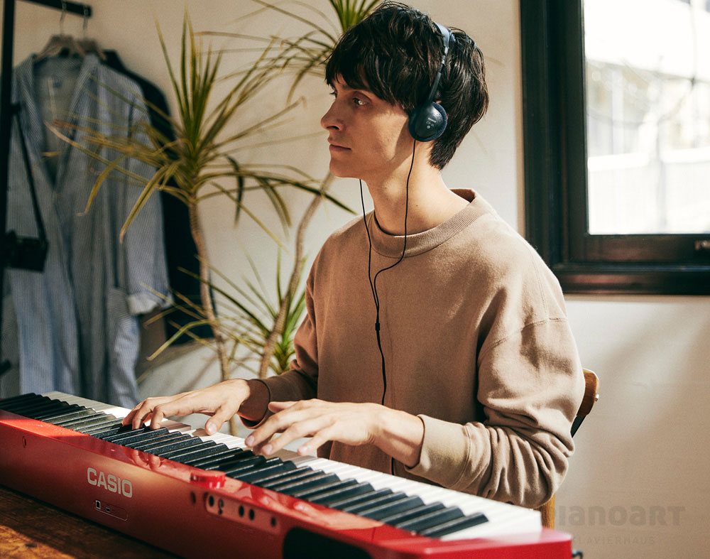 Digital Piano Casio PX-S1100 RD spielt Mann
